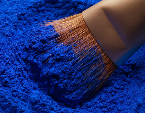 Close up of brush with blue powder