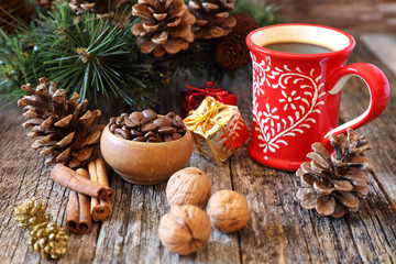Cup of coffee, coffee beans and New-Year  decorations