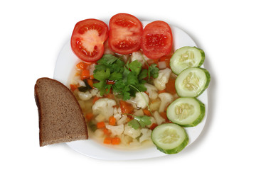 Porcelain plate with vegetable soup on white background