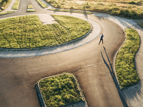 Businessman running in roundabout