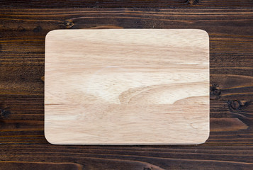 wooden cutting board on wood table background