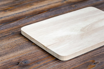 wooden cutting board on wood table background