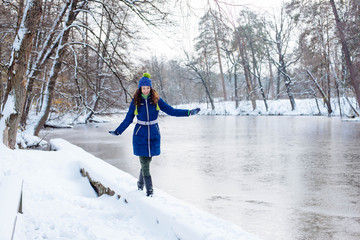 young female enjoying winter in snowy park
