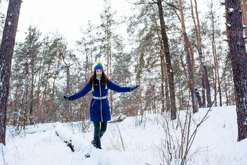 young female enjoying winter in snowy park