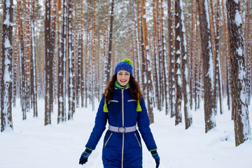 young female enjoying winter in snowy park