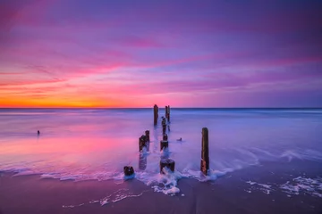 Schilderijen op glas Seascape sunrise with vibrant clouds  © Michael