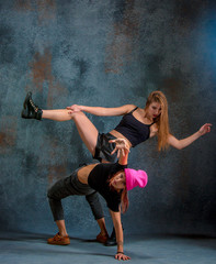 Fototapeta na wymiar The two attractive girls dancing twerk in the studio
