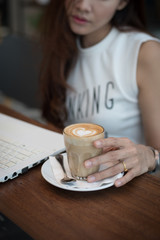 coffee latte art with woman hand