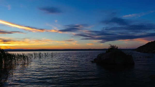 Timelapse of sunset with beautiful cloudy sky over the Bukhtarma reservoir, Altai, Kazakhstan (4K UHD) 