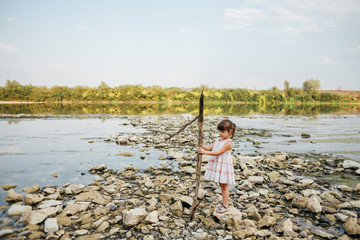 Fototapeta premium girl holding a dry branch of the river