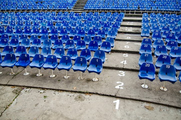 Empty auditorium with blue numbered chairs