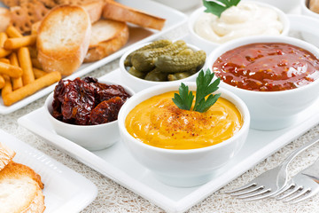 assortment different sauces and snacks