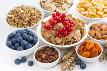 assortment of different breakfast cereal, dried fruit 