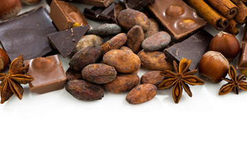 background with cocoa beans, various chocolate and spices