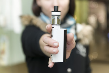 Close up of a woman inhaling from an electronic cigarette