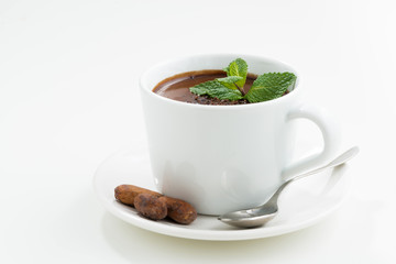 cup with hot mint chocolate on white table