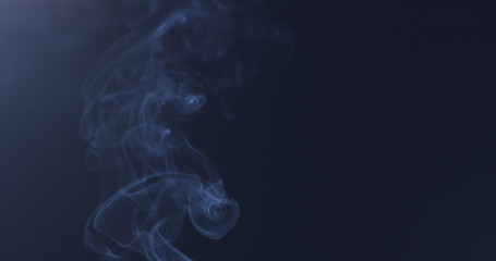 mystery blue smoke over dark background with copy space