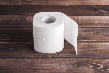 Toilet paper on wooden background