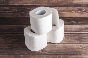 Toilet paper on wooden background