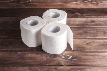 Toilet paper on wooden background