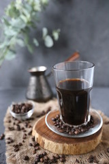 iced coffee with coffee beams on dark table