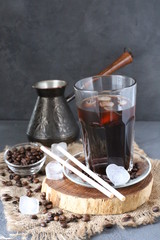 iced coffee with coffee beams on dark table