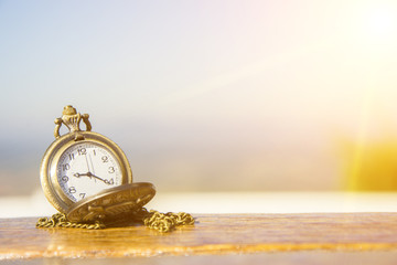 watch locket on the wooden table and flare