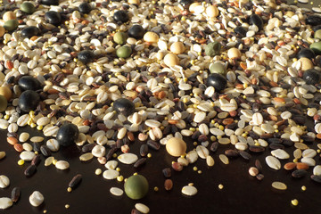 Cereals and beans on wood background