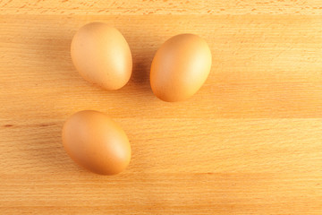 Home cooking concept, fresh organic eggs on wooden board backgro