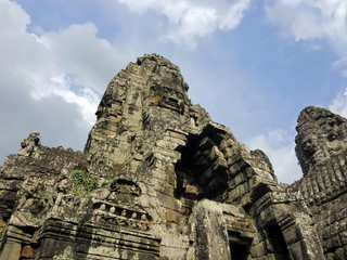 Fototapeta premium Bayon temple with carved stone faces in Siem Reap Cambodia jungle