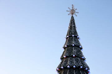 decorated Christmas tree on the background of blue sky