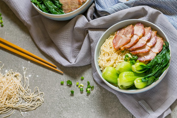 delicious egg noodle with red pork and vegetable in bowl
