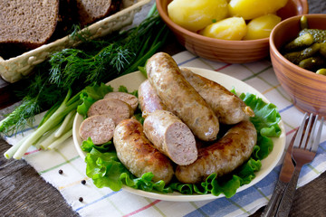 Homemade meat smoked sausage and a variety of vegetables, herbs