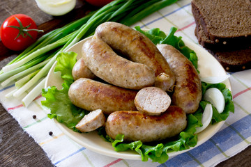 Homemade meat smoked sausage and a variety of vegetables, herbs