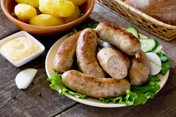 Homemade meat raw sausage, vegetables, herbs and boiled potatoes