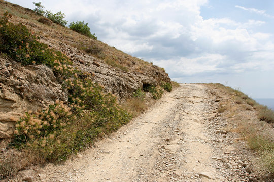 The landscape with the earth road on the hillside. This photo was taken on the Meganom cape in Crimea.