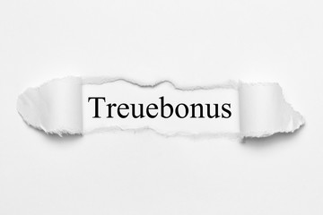 Treuebonus auf weißen gerissenen Papier