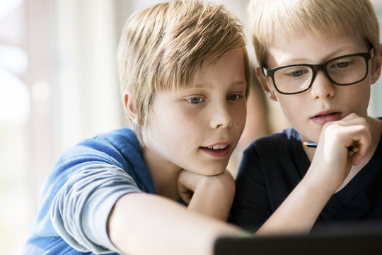 Boys using  laptop