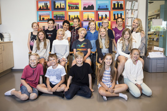 Portrait of happy school children in classroom