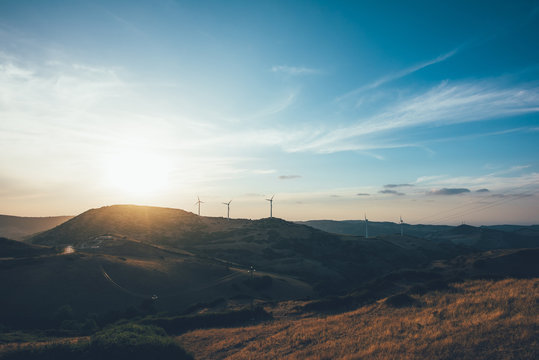 Sunset over wind turbines on rolling landscape, Osilo, Sassari, italy