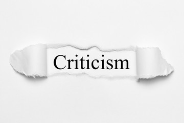 Fototapeta premium Criticism on white torn paper