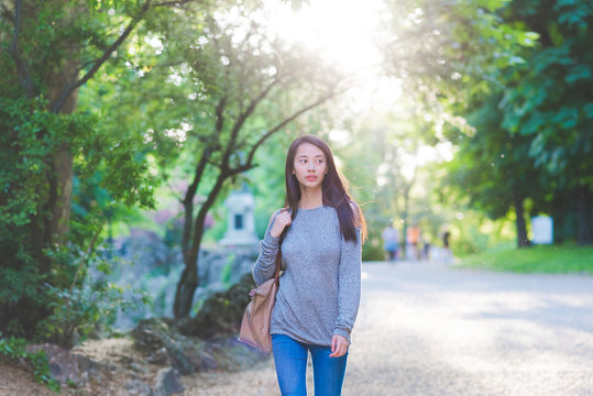 Young woman strolling in park