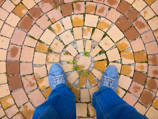 Feet on the cobblestone.