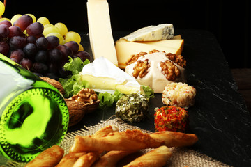 Cheese platter with different cheese and grapes 
