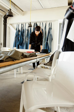 Fashion designer in sample room working at table