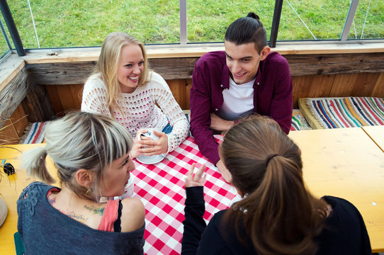 Four adult friends talking in cafe