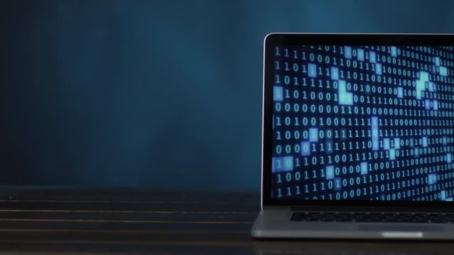 laptop with blue colored digital binary code at half