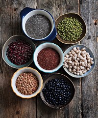 Healthy food - lentils, chickpeas, black beans, red beans, peas, quinoa and chia seeds on old wooden background.