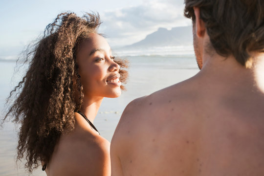 Young woman gazing at boyfriend on beach, Cape Town, Western Cape, South Africa