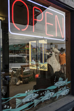 Neon open sign in fishmongers shop window, Homer Spit, Kachemak Bay, Alaska, USA